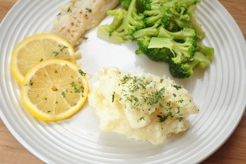 Healthy Dinner with Mashed Potatoes, Broccoli, Lemon and Fish