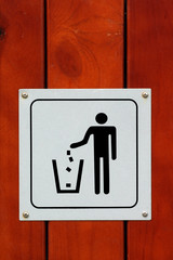 Trash sign on wood