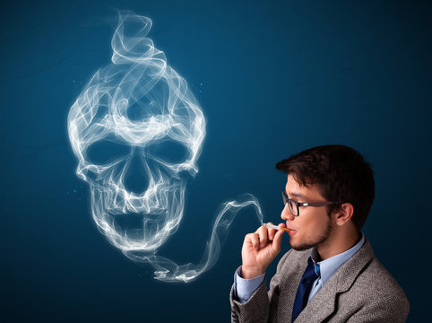 Young man smoking dangerous cigarette with toxic skull smoke