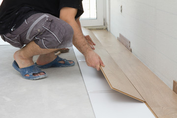 Worker assembling laminate floor