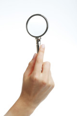 Hand holding a magnifying glass