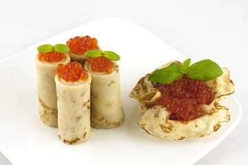 pancakes with caviar on a white plate