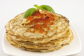 pancakes with caviar on a white plate
