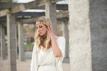 Fototapeta premium Beautiful woman with hand to hair outdoors