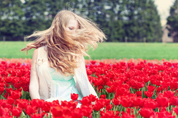 woman in a red tulip field