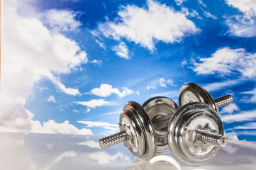 Fitness objects on the blue sky background