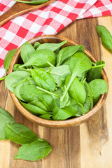 Spinach. Young spinach in a wooden bowl