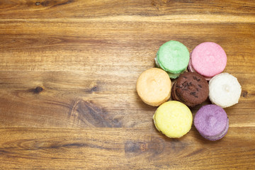Fototapeta na wymiar Tasty colorful macaroon on wooden background with copy space.
