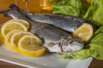 Raw, whole trout, mediterranean theme