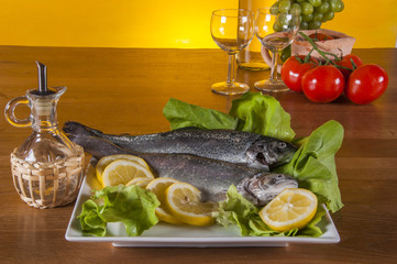 Raw fish on the plate, mediterranean theme