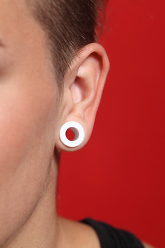 Close up of a woman ear with an ear plug