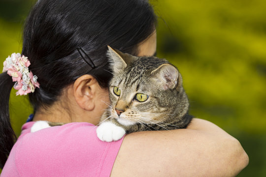 Matue woman holding her Family Cat