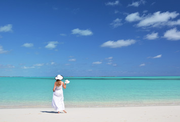 Fototapeta na wymiar Girl on the desrt beach. Exuma, Bahamas