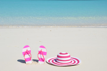 Flip-flops and hat on the beach