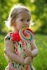 Portrait of a little girl with a lollipop