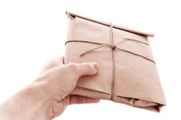 Man's hand with envelope tied with a rope