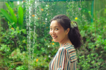 Naklejka premium young girl smiling with a white butterfly clings to her hair