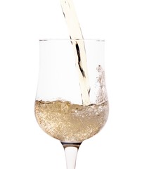 Side view of white sparkling wine pouting in glass