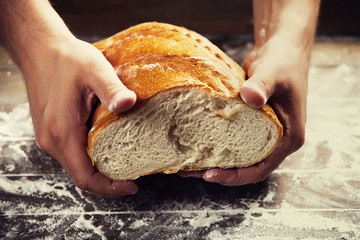 Baker's hands with a bread