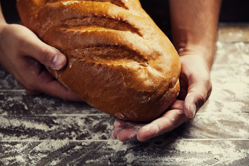 Baker's hands with a bread