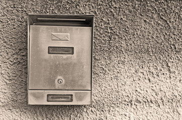 metal post box in sepia tone