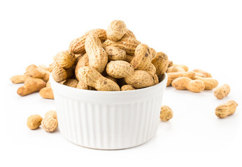 shelled great peanuts in a bowl on white background, closeup