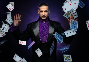 Young brunette magician in stage costume 