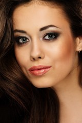 Fototapeta premium Portrait of a young beautiful cheerful brunette woman 