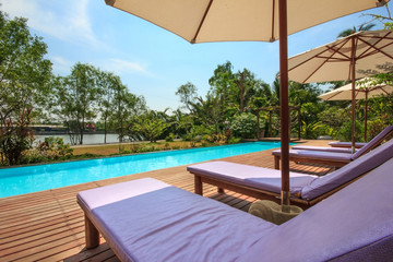 Fototapeta na wymiar Chair beside the pool and relaxing in the beautiful resort