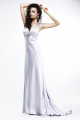 Fototapeta na wymiar Lady in Light Silk Sleeveless Dress. Platinum Jewelry. Beauty