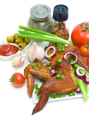 Smoked chicken wings, vegetables and spices on a white backgroun