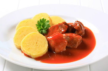 Pork in tomato sauce with potato dumplings