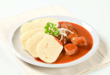 Pork meat in tomato sauce with dumplings