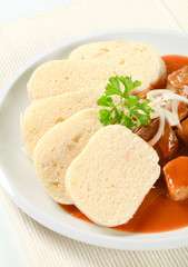 Pork meat in tomato sauce with dumplings