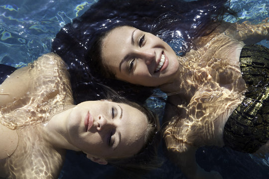 two girls at a swimming pool