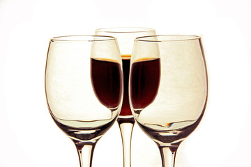 a glass of wine and empty glasses.