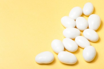white jordan almonds on yellow background