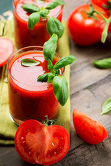 Tomato Juice and Fresh Tomatoes with Basil on a Wooden Table