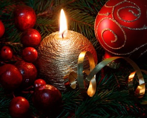 Candle burning amongst twigs of the spruce