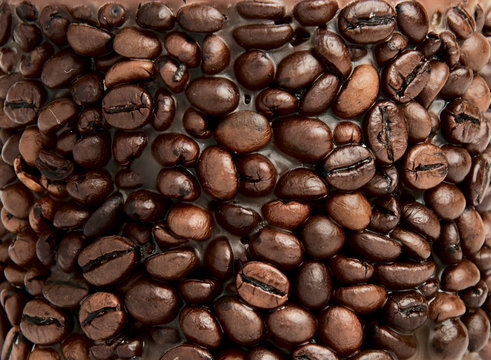 Coffee background. Heap of bronze coffee grains
