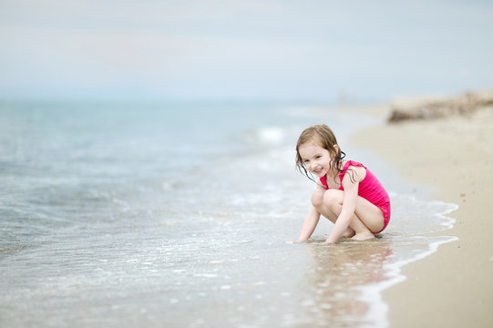 Adorable little girl on a sandy beach