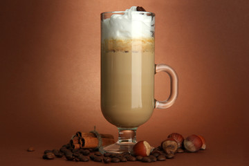 Fragrant coffee latte in glass cup with spices,