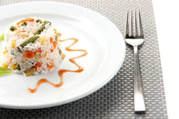 Delicious risotto with vegetables, isolated on white