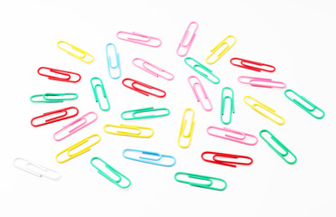 Scattered paper clips on white background