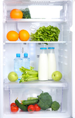 Open refrigerator with vegetarian food