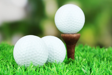 Golf balls on grass outdoor close up
