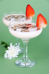 Fruit smoothies on green background