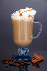 Layered coffee in glass on table on grey background