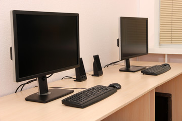 Computers on tables in room