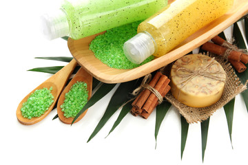 Bottles with scrub and hand-made soap, isolated on white